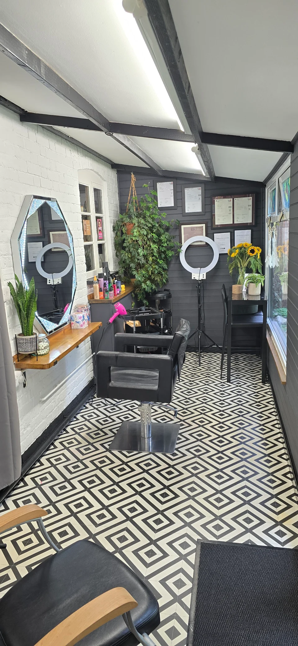 Phoenix 47 salon interior with styling chair, mirrors and black-and-white patterned floor